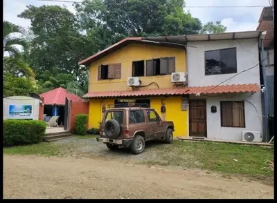 a car parked in front of a house at Cabinas la Antorcha in Dominical