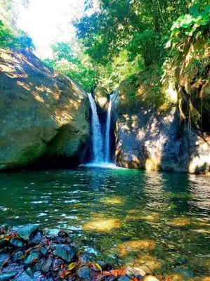 a waterfall in the middle of a pool of water at Cute studio-apartment near the beach in Uvita