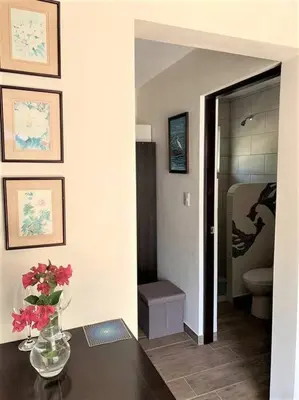 a room with a vase of flowers on a table at Cute studio-apartment near the beach in Uvita