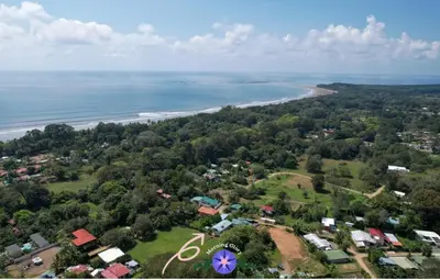 an aerial view of a town and the beach at Cute studio-apartment near the beach in Uvita