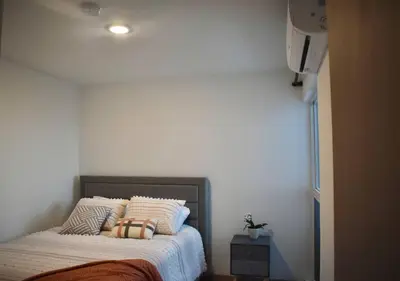 a bedroom with a bed with two pillows on it at Lulo Jaco New ocean view apartment in Jacó
