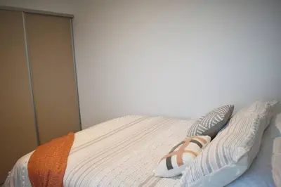 a bed with two pillows on top of it at Lulo Jaco New ocean view apartment in Jacó