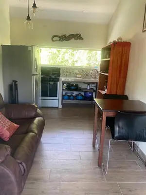a living room with a couch and a table at Apartment with large terrace and garden view in Uvita