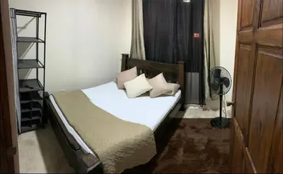 a bedroom with a bed with white sheets and pillows at La Fortuna Raft House in Fortuna