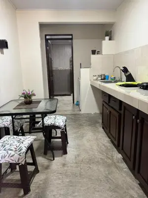 a kitchen with a table and chairs and a sink at La Fortuna Raft House in Fortuna