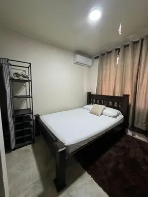 a bedroom with a bed and a book shelf at La Fortuna Raft House in Fortuna