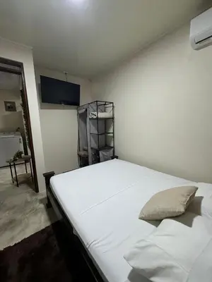a bedroom with a large white bed in a room at La Fortuna Raft House in Fortuna