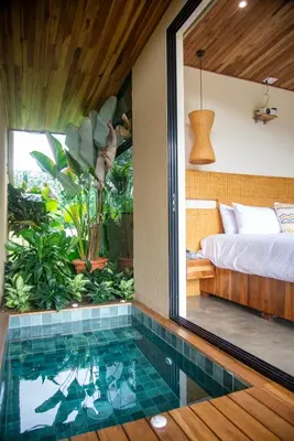 a house with a pool in the middle of a bedroom at Scenic Volcano Villas with Hot Tub in Fortuna