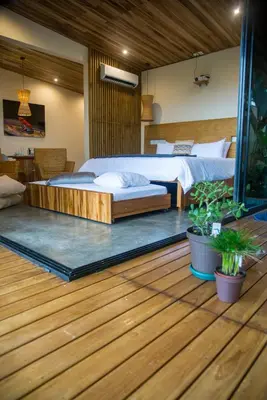 a bedroom with a bed and a wooden floor at Scenic Volcano Villas with Hot Tub in Fortuna