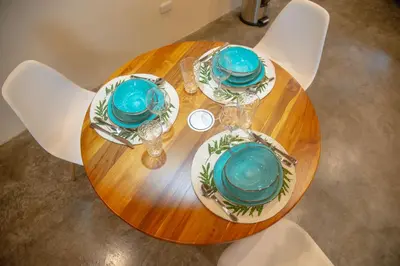 a wooden table with blue plates and dishes on it at Scenic Volcano Villas with Hot Tub in Fortuna