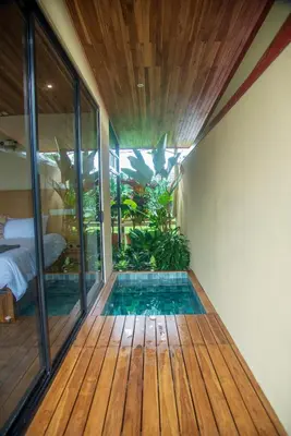 a room with a swimming pool on a wooden floor at Scenic Volcano Villas with Hot Tub in Fortuna