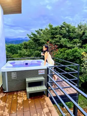 a woman standing in a hot tub on a deck at Nambí Monteverde in Monteverde Costa Rica
