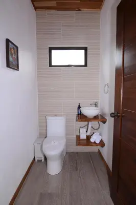 a bathroom with a toilet and a sink at Nambí Monteverde in Monteverde Costa Rica