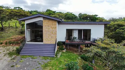 a small house on a hill with a deck at Nambí Monteverde in Monteverde Costa Rica