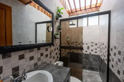 a bathroom with a sink and a mirror at Villa Tucán - La Fortuna in Fortuna