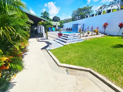 a building with stairs and a grass yard at Villa Tucán - La Fortuna in Fortuna