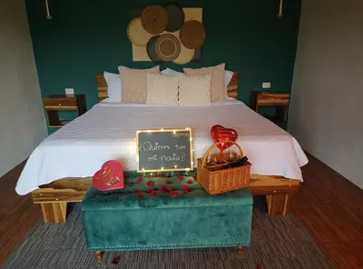 a bed with a sign and a basket of hearts at Villa deluxe, jacuzzi, cocina in Fortuna