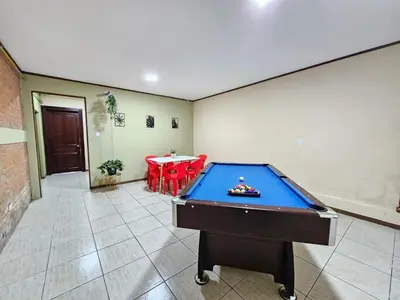 a pool table in a room with a table at Hostel La Cali Inn in San José