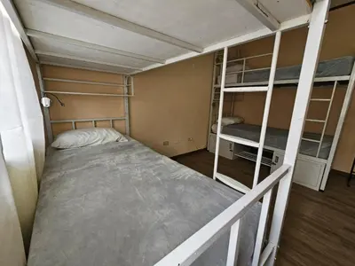 a room with two bunk beds in it at Hostel La Cali Inn in San José