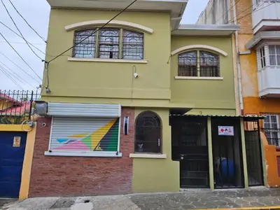 a building with a painting on the side of it at Hostel La Cali Inn in San José