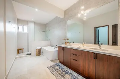 a bathroom with a sink and a toilet and a mirror at Golden Palms#10 in Playa Flamingo