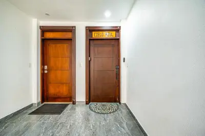 two wooden doors in a hallway with a sign above them at Golden Palms#10 in Playa Flamingo
