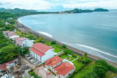 an aerial view of a beach with houses and the ocean at Golden Palms#10 in Playa Flamingo