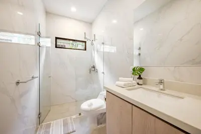 a bathroom with a shower and a toilet and a sink at Villa Juntos in Tamarindo