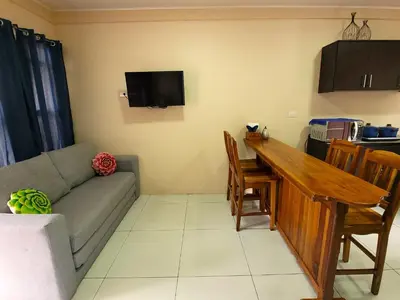a living room with a couch and a table at Arenal Honey House in Fortuna