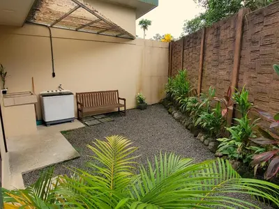 a patio with a bench and a fence at Arenal Honey House in Fortuna