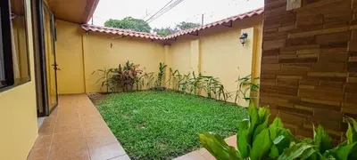 a garden in the side of a house at Cozy 3 Bedroom House 5mins from the Airport in Alajuela City