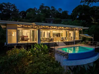 a house with a swimming pool in front of it at Ocean View Villa With Pool and Spectacular Sunsets in Ballena