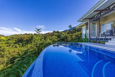 a swimming pool in front of a house at Ocean View Villa With Pool and Spectacular Sunsets in Ballena