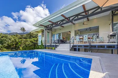 an exterior view of a house with a swimming pool at Ocean View Villa With Pool and Spectacular Sunsets in Ballena