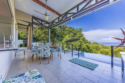 an open kitchen and dining room with a view of the ocean at Ocean View Villa With Pool and Spectacular Sunsets in Ballena