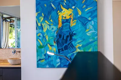 a painting on a wall next to a table at Ocean View Villa With Pool and Spectacular Sunsets in Ballena