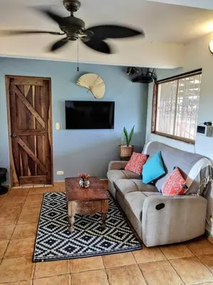 a living room with a couch and a table at Casa Macondo 3 bdrm w private pool, close to beach, Esterillos Oeste in Esterillos Este