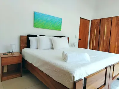 a bedroom with a large bed with white pillows at Villa Luxury Volcano Paradise Retreat in Fortuna