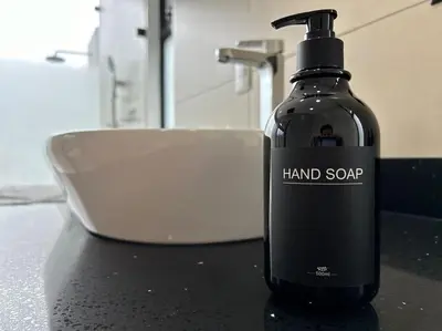 a black bottle of hand soap sitting on a counter at Villa Luxury Volcano Paradise Retreat in Fortuna