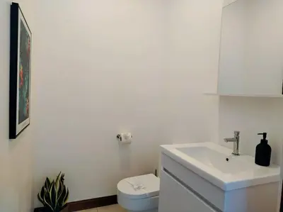 a white bathroom with a sink and a toilet at Villa Luxury Volcano Paradise Retreat in Fortuna
