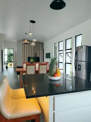 a kitchen and living room with a table and chairs at Villa Luxury Volcano Paradise Retreat in Fortuna