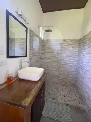 a bathroom with a sink on a wooden counter at Villas Casa Paz in Cóbano