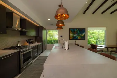 a kitchen with a large island in the middle at Casa Forest 4 bdrs private pool in Los Suenos in Herradura