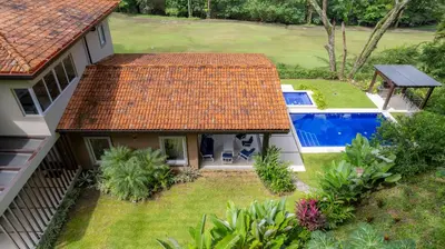 an aerial view of a house with a swimming pool at Casa Forest 4 bdrs private pool in Los Suenos in Herradura