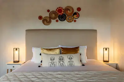 a bedroom with a bed with hats on the wall at Yaloco House Monteverde in Monteverde Costa Rica