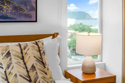 a bedroom with a bed and a lamp on a table at Incredible Views - Brand-New 3BR Condo in Jacó