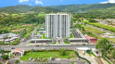an aerial view of a city with a tall building at Incredible Views - Brand-New 3BR Condo in Jacó
