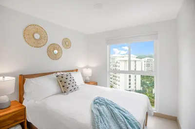 a bedroom with a white bed and a window at Incredible Views - Brand-New 3BR Condo in Jacó