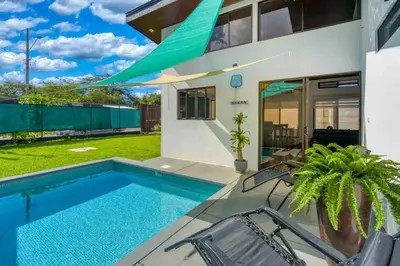 a swimming pool in the backyard of a house at Casa Maiki Your Private Retreat in Uvita Center in Uvita