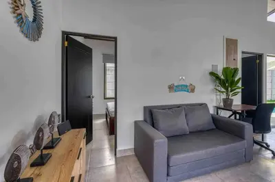 a living room with a couch and a table at Casa Maiki Your Private Retreat in Uvita Center in Uvita